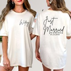 two women wearing matching t - shirts with just married written on the front and back