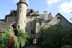 an old castle with ivy growing on it's walls and walkway leading to the entrance