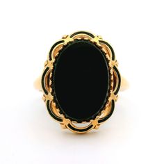 -Stone(s)- (1) Natural Genuine Onyx - Oval Cut - Multi Prong Set - Black Color  - 13.62 x 9.68mm (approx.) Material: Solid 10k Yellow Gold Weight: 3.59 Grams Ring Size: 7.0 ( fitted on finger, please contact us prior to purchase with sizing inquiries) Ring Width: 18.3mm (0.72") (top of the ring - north to south) - 1.74mm (bottom of the shank) Ring Height: 5.5mm (rise off finger) Condition: Vintage, light wear. Original finish & patina intact. Excellent overall condition. Stock Number: JO-3901053 Cocktail Ring, Black Enamel, Cocktail Rings, Oval Cut, Prong Setting, Onyx, Black Color, Patina, Gold Rings