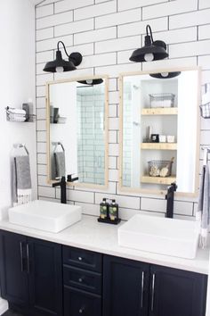 a bathroom with double sinks and two mirrors on the wall next to eachother