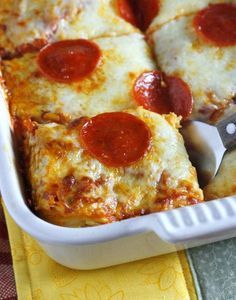 pepperoni pizza in a white casserole dish with a spatula and yellow napkin