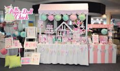 a pink and white display with lots of decorations