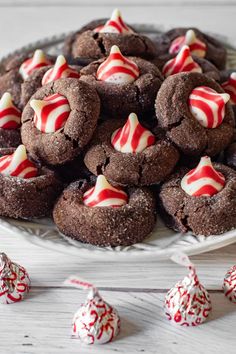 a plate full of chocolate cookies with candy canes