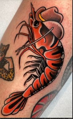 a man with a lobster tattoo on his leg