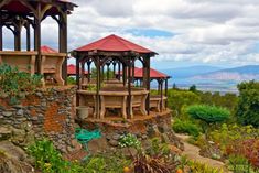 an outdoor gazebo on top of a hill