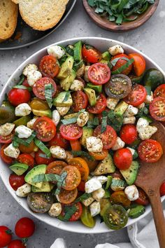 a salad with tomatoes, cucumbers and mozzarella