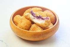 a wooden bowl filled with food on top of a table