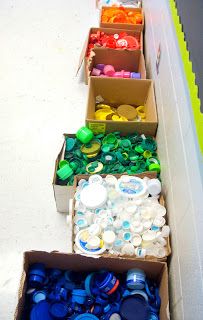 several boxes filled with different colored plastic bottles