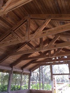 the inside of a building with wooden beams and wood flooring on top of it