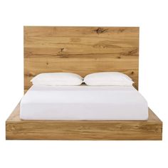 a bed with white sheets and pillows on it's headboard is made from wood