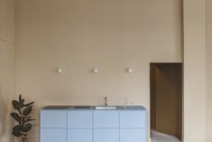 a blue cabinet and sink in a room