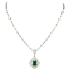 A stunning green emerald and diamond necklace in a classic design. 1.84 carat GIA certified emerald cut Green Emerald. The emerald is surrounded by diamonds and hangs from a diamond necklace featuring 9.40 carats of diamonds F-G in color. 18k white gold 16.5 inch necklace -- but can be adjusted. Emerald Jewelry Set White Gold, Scene Green, Emerald And Diamond Necklace, Emerald Jewellery, Green Pendant Necklace, White Gold Pendant Necklace, Vintage Pendant Necklace, Green Pendant, Necklaces Pendant