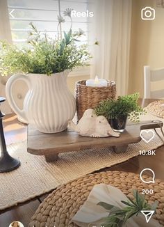 the table is set with candles and flowers in vases on it, along with wicker place mats