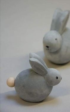 two ceramic rabbits sitting next to each other