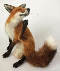 a stuffed fox sitting on its hind legs