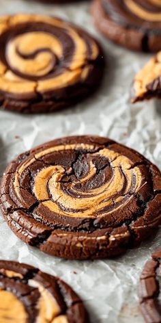 chocolate cookies with orange swirls on parchment paper