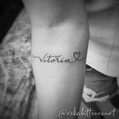 a woman's arm with the word victoria written in cursive writing on it