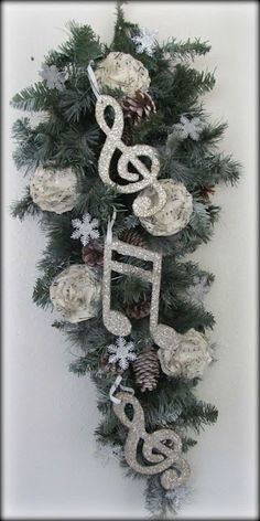 a christmas tree decorated with musical notes and pine cones