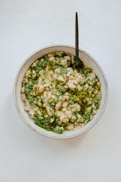 a white bowl filled with food on top of a table