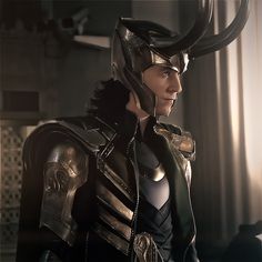 a man dressed up as loki in the avengers age of ulhance movie, with horns on his head