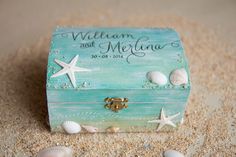 a small wooden box with shells and starfish on the beach