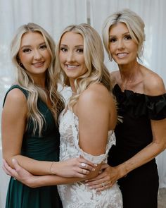 three beautiful women standing next to each other