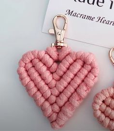 two crocheted heart shaped keychains are on display