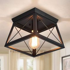 a light fixture hanging from the ceiling in a living room