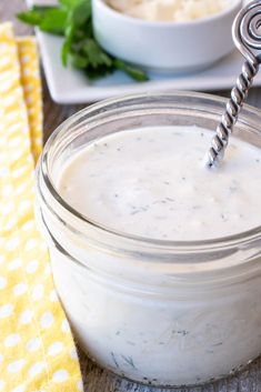 a glass jar filled with yogurt sitting on top of a table