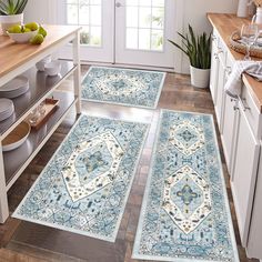 three blue rugs in the middle of a kitchen