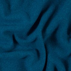 a close up view of a blue fabric textured with dark teal colored material