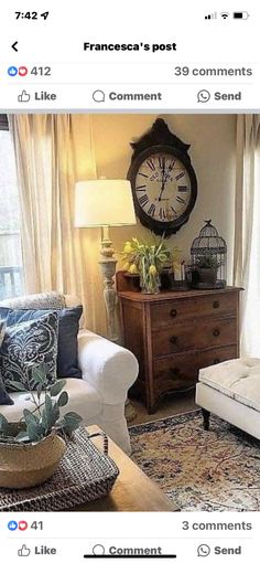 a living room filled with furniture and a large clock on the wall above it's windows