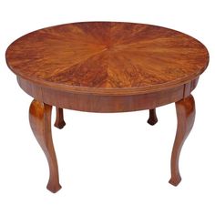 a round wooden table with an intricate design on the top