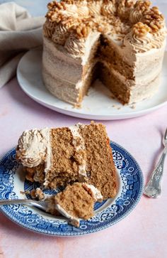 a piece of cake on a blue and white plate next to a slice of cake