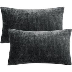 two dark grey velvet pillows on a white background