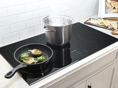 a pan with some vegetables cooking on the stove