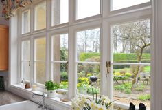 the kitchen window is open to let in some fresh flowers