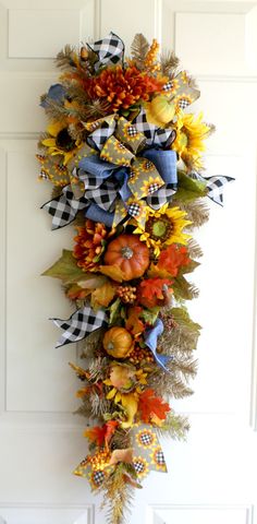 a fall wreath hanging on the front door