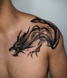 a man's chest with a black dragon tattoo on it