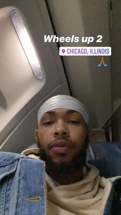 the man is wearing a headband and sitting on an airplane with his eyes closed