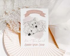 a card with an image of two dogs on it and a ribbon around the edge