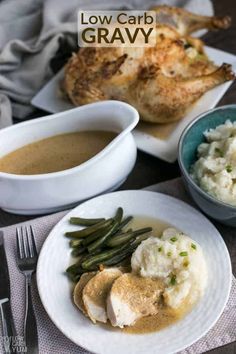 a plate with chicken, mashed potatoes and green beans on it next to a bowl of gravy