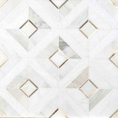 a white marble tile with gold trimmings and diamond shaped design on the side