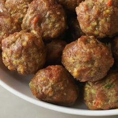 a white bowl filled with meatballs on top of a table