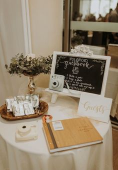 a white table topped with a sign and other items