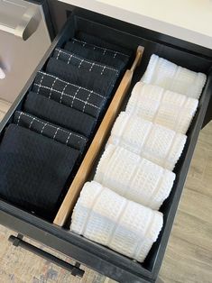 two trays filled with black and white towels