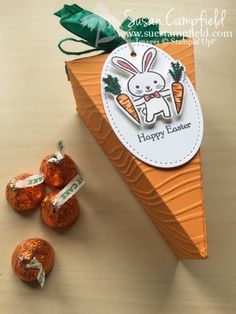 an orange box with some candies in it and a tag that says happy easter