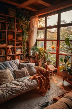 a living room filled with lots of furniture and windows covered in blankets on top of them