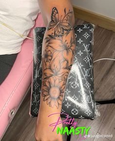 a woman's arm with flowers and butterflies tattooed on her left arm, next to a purse