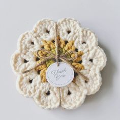 a crocheted doily with a thank you tag attached to the front of it